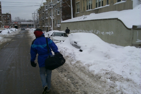 Rachel walking along street with more buried cars