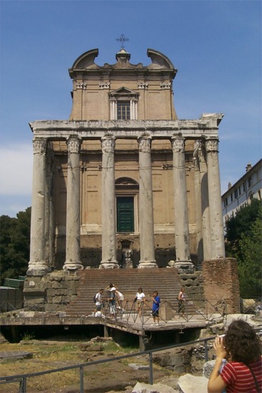 The Temple of Divus Antoninus and Diva Faustina. This temple was built by Antoninus Pius for his wife after her death and deification in 140 AD. The church of Saint Lorenzo in Miranda was built in the 7th century as an attachment to the temple, and is basically the building behind the pillars.