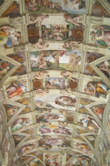 ... This photo encompasses most of the ceiling of the chapel.  What you will notice is that Michelangelo transformed the dimensionless in to one that seems as though there are gobs of detail and structure.  All of the angles and pillars in the photo and on the ceiling are not truly angles and pillars; they are simply, or really not so simply, the masterpiece of Michelangelo.  He gave dimension to the dimensionless.
