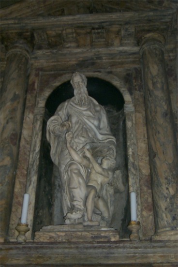 A sculpture on the wall inside the church.