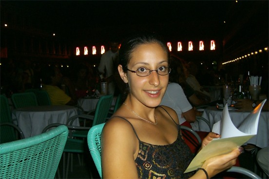 Rachel ordering some midnight dessert.  In the background along the opposing side of the square to the church were LED screens displaying alternating fire and waterfall scenes.  It was a temporary art display.