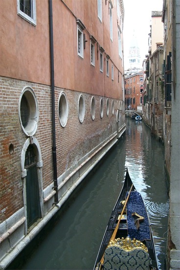 A gondola going down one of the canals.  I liked this shot with the circular windows.