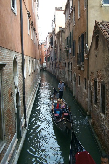 Gondola going down a canal.  We would later take a ride of our own.