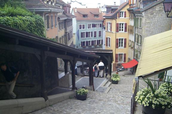 Looking down Escaliers du Marché a medieval stair case with shops alongside.