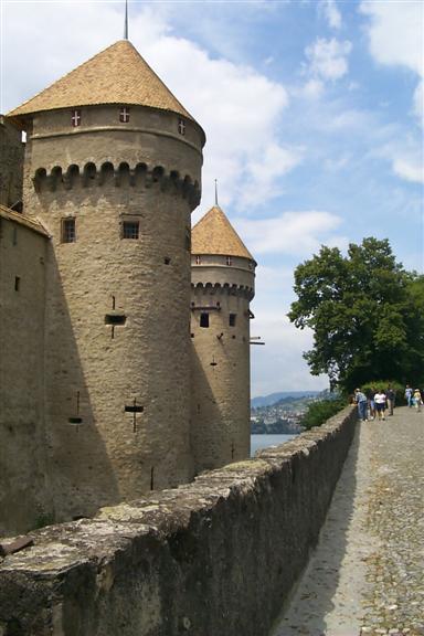 The castle is sitting on rock that is in the water, so the castle is surrounded by water on all sides.  