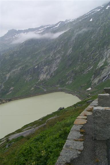 The lake is formed by the Seeuferegg dam, at the top of the water in this shot.  All of the rock you see in the mountains here is granite, and lots of it.