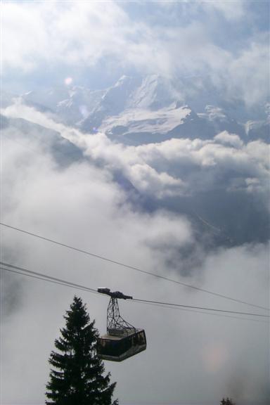 Neat shot of a gondola coming from Gimmelwald and cloud rising behind it.