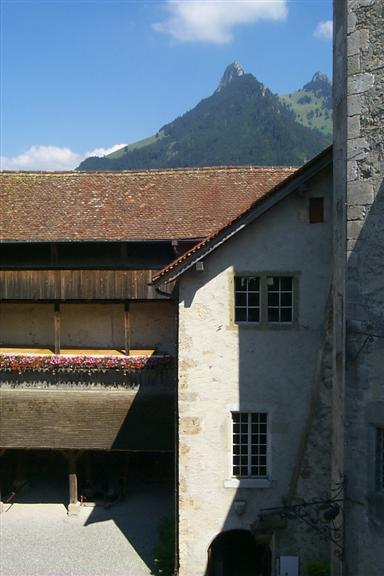 Court yard within castle and Alps behind.