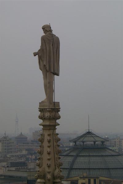 I like this shot of a sculpture on the top of the spire with the roof of the Vittorio Emmanuale Arcade behind.